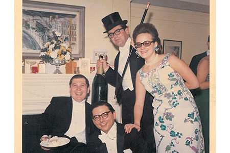 Edward Hutton in top hat, with his wife, Caroline, celebrate with friends